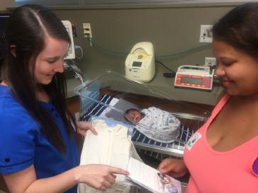 Allyson, BSN, McLane Children’s Neonatal Intensive Care Unit Nurse discusses best safe sleeping practices with new mother, Faith and son, Nicholas.